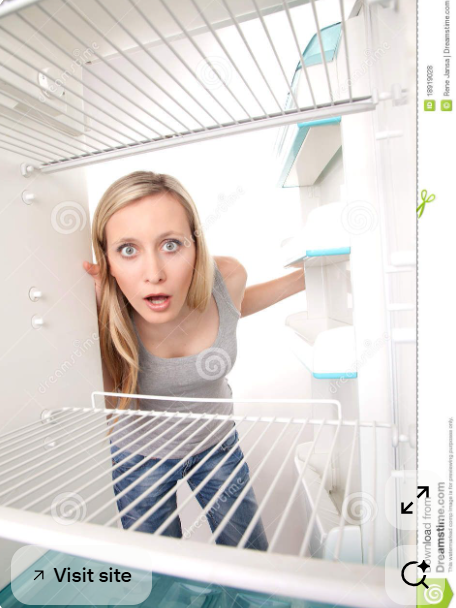 this is a stock image of a blonde woman looking into a fridge whereas the perspective of the camera is within the fridge.